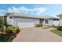 Lovely home featuring a two-car garage and beautifully manicured bushes and landscaping at 3418 Raleigh Dr, Winter Haven, FL 33884