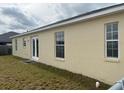 Spacious backyard showing the exterior of the house with white trim windows and doors at 360 Lake Eloise Pointe Dr, Winter Haven, FL 33880