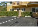 Close-up of the condo with clearly marked parking space and lush green hedges at 400 El Camino Dr # 101, Winter Haven, FL 33884