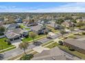 Aerial view of a residential neighborhood with houses and tree-lined streets at 452 Palastro Ave, Auburndale, FL 33823