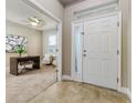 Inviting entryway with neutral tile flooring and a bright view into the office at 452 Palastro Ave, Auburndale, FL 33823