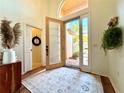 Bright foyer with hardwood floors and a stylish rug, featuring a welcoming entryway and natural light at 4540 Turnberry Ln, Lake Wales, FL 33859