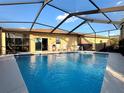 Sparkling screened-in pool with ample seating and sunny sky views, perfect for outdoor relaxation at 4540 Turnberry Ln, Lake Wales, FL 33859