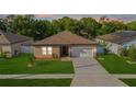 Inviting home featuring a manicured lawn and extra-long driveway at 4924 Saint James St, Winter Haven, FL 33881