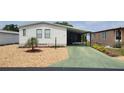 Inviting single-story home with a covered carport and low-maintenance landscaping at 6059 Southern Oaks Se Dr, Winter Haven, FL 33884