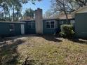 View of backyard showing mature trees, a chimney and ample space at 618 Chester Dr, Lakeland, FL 33803