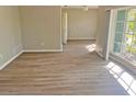 Bright living room featuring laminate floors and a large window for ample natural light at 618 Chester Dr, Lakeland, FL 33803