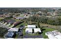 An aerial view of a tranquil residential area, featuring well-maintained homes surrounded by lush greenery and mature trees at 720 Fonda Ct # 54, Lakeland, FL 33803