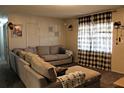 Comfortable living room featuring a large sectional sofa, natural light, and stylish decor at 807 S 1St St, Lake Wales, FL 33853