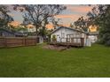 Expansive backyard featuring a wooden deck, a shed, and a privacy fence at 907 Vistabula St, Lakeland, FL 33801