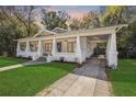 Charming home with a covered front porch and driveway leading to a covered carport at 907 Vistabula St, Lakeland, FL 33801