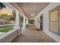 Spacious front porch with string lights, decorative columns, and a porch swing at 907 Vistabula St, Lakeland, FL 33801