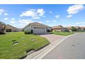 Street view of a cozy home with a neatly maintained lawn and driveway at 1017 Sawgrass Dr, Winter Haven, FL 33884