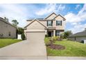 Charming two-story home with neutral paint, attached garage, manicured lawn, and beautiful landscaping at 1018 Roberta Rd, Lake Wales, FL 33853