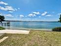 Beautiful lake view with a sandy beach and dock under a sunny, partly cloudy, blue sky at 1050 E Eagle Ave, Eagle Lake, FL 33839