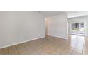 Spacious living area with tile flooring, bright walls, and a sliding door to the exterior at 1229 Rawls Dr, Lakeland, FL 33801