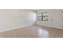 Bright, airy living room with neutral walls, tile floors, and a window offering natural light at 1229 Rawls Dr, Lakeland, FL 33801