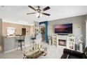 Open living area with a cozy fireplace and decorative accents at 1817 Manitoba Ct, Poinciana, FL 34759