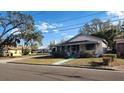 Charming home with a covered front porch on a sunny day at 201 Dr J A Wiltshire W Ave, Lake Wales, FL 33853