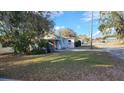 Exterior view of a cozy home with a spacious, green lawn at 201 Dr J A Wiltshire W Ave, Lake Wales, FL 33853