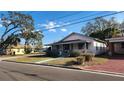 Charming home with a covered front porch, surrounded by a lush lawn at 201 Dr J A Wiltshire W Ave, Lake Wales, FL 33853
