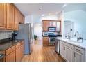 Bright kitchen features stainless steel appliances and wood cabinets at 2706 Rochelle Dr, Winter Haven, FL 33881
