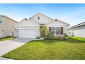 Charming single-story home with a well-maintained lawn and a two-car garage at 2759 Grandbury Grove Rd, Lakeland, FL 33811