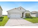 Charming single-story home with a well-maintained lawn and a two-car garage at 2759 Grandbury Grove Rd, Lakeland, FL 33811