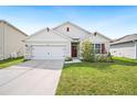 Charming single-story home with a well-maintained lawn and a two-car garage at 2759 Grandbury Grove Rd, Lakeland, FL 33811
