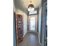 Bright entryway features tile flooring, a decorative screen, and a glass-paneled front door for natural light at 37 Enclave Dr, Winter Haven, FL 33884
