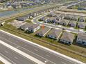 Overhead view of a neighborhood featuring a modern home, close to a main road and community waterways at 3821 Giorgio Dr, Winter Haven, FL 33884