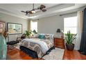 Serene bedroom with hardwood floors, tray ceilings, and large windows at 3834 Bedford Ave, Winter Haven, FL 33884