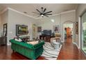 Elegant living room featuring a plush green sofa, hardwood floors, and stylish decor at 3834 Bedford Ave, Winter Haven, FL 33884