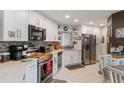 Bright kitchen with white cabinets, modern stainless-steel appliances, and tile backsplash at 4422 Glenns Lndg, Winter Haven, FL 33884