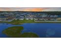 Expansive aerial shot showcasing a home situated near a scenic lake within a residential community at 5767 Lakeside Landings Blvd, Winter Haven, FL 33881
