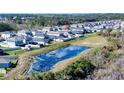 Aerial view of homes in a peaceful community with a scenic pond at 578 Preserve Pointe Blvd, Davenport, FL 33837
