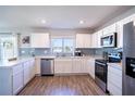 Bright kitchen with stainless steel appliances, white cabinets, and a tiled backsplash at 578 Preserve Pointe Blvd, Davenport, FL 33837