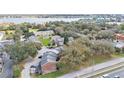 Scenic aerial view of brick townhomes with mature trees, nearby lake, and community amenities at 5850 Cypress Gardens Blvd # 206, Winter Haven, FL 33884