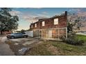 Rear exterior showing brick facade, enclosed back patio, and rear parking area at 5850 Cypress Gardens Blvd # 206, Winter Haven, FL 33884