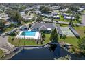 Aerial view showcasing a community pool, recreation courts, and scenic waterfront homes at 6053 Southern Oaks Se Dr, Winter Haven, FL 33884
