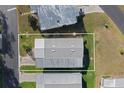 An aerial view of a manufactured home with a gray roof, surrounded by green lawns in a sunny community at 6053 Southern Oaks Se Dr, Winter Haven, FL 33884
