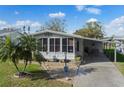 Well-maintained home featuring a covered carport, landscaped garden, and a welcoming entrance at 6053 Southern Oaks Se Dr, Winter Haven, FL 33884