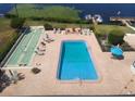 Outdoor pool and shuffleboard court with lounge chairs and tables at 700 Mirror Nw Ter # 111, Winter Haven, FL 33881