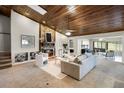 Spacious living room with stone fireplace and wood ceiling with skylight at 7016 Village Dr, Lake Wales, FL 33898