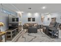 Comfortable living area with a plush gray sofa and stylish marble-patterned rug at 734 Canberra Rd, Winter Haven, FL 33884