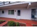 A close up of the front door of the apartment with a small garden area and an assigned parking spot at 1100 Martinique Dr # 106, Winter Haven, FL 33884