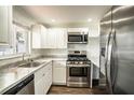 This is a nicely updated kitchen featuring stainless steel appliances, granite countertops and new cabinets at 1100 Martinique Dr # 106, Winter Haven, FL 33884