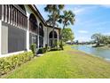 Picturesque backyard overlooking a serene pond surrounded by lush greenery and swaying palm trees at 1103 Country Club Dr # A-3, Lake Wales, FL 33898