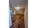 Spacious living room with wood-look floors and ceiling fan at 1130 N Lake Parker Ave # E231, Lakeland, FL 33805