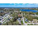 Aerial view of the neighborhood near a lake and surrounded by lush trees and landscaping at 1325 4Th Ne St, Winter Haven, FL 33881